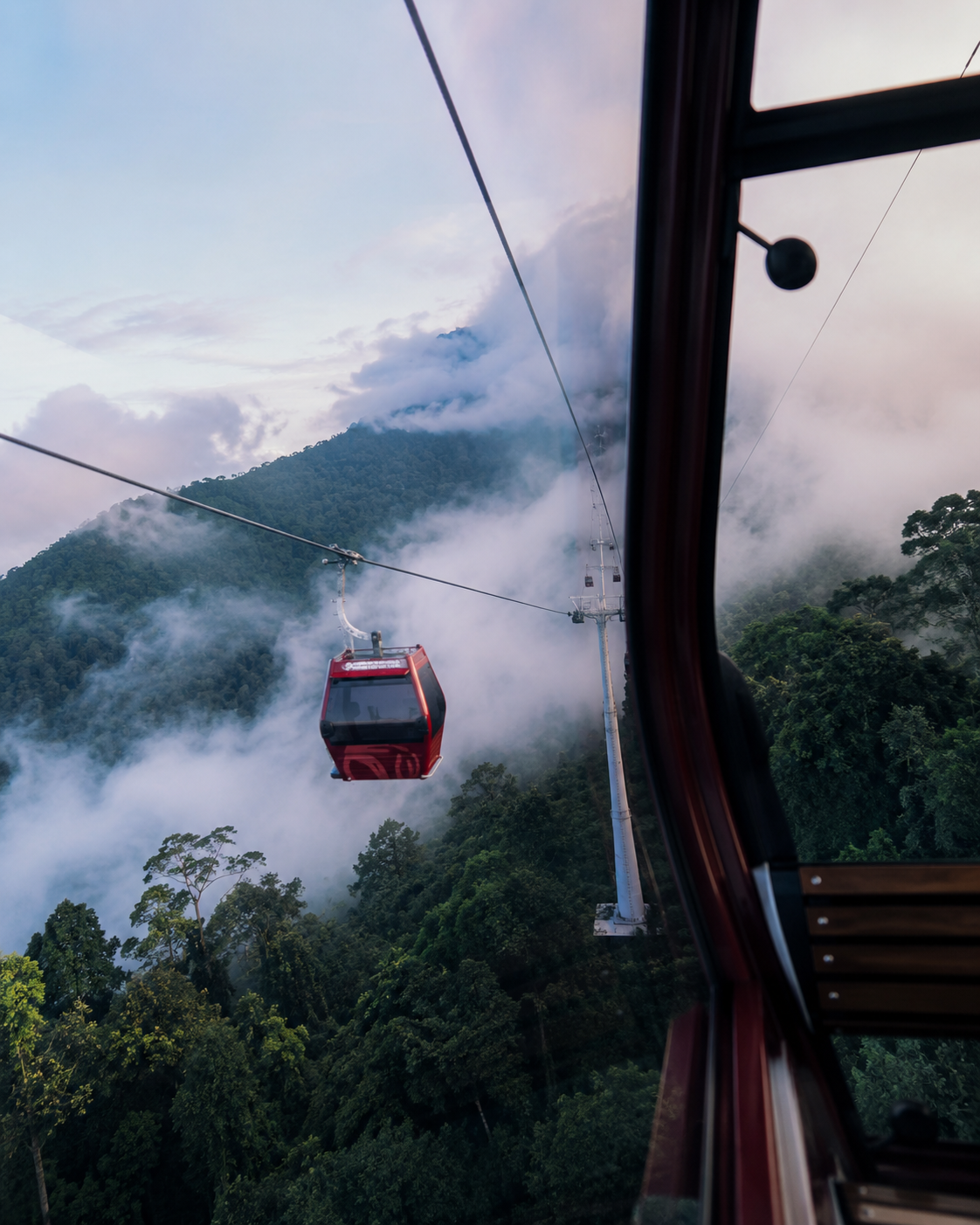 Genting Highlands Awana Skyway cable car through misty mountain forest